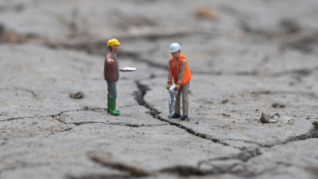 two little men working in a demolition site
